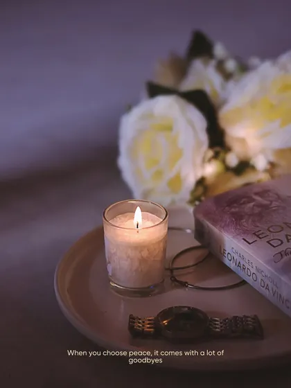 A peaceful flatlay with a candle, a book, and flowers. I love creating these compositions that evoke a sense of calm and choosing peace.