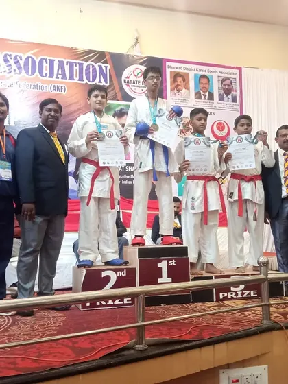 My student on the first-place podium at the AKSKA State Level Championship, a significant victory for him and our school.
