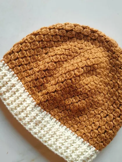 Here is the Flora beanie in a warm brown and cream color combination. The hat is worked top-down and features a cozy ribbed brim.