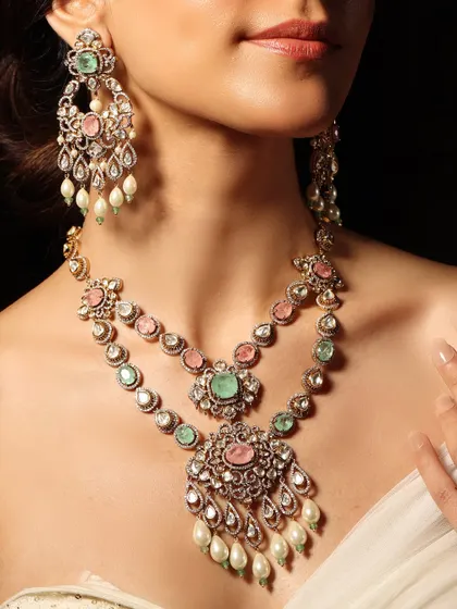A romantic, layered necklace combining pastel pink and green stones with delicate pearl drops.