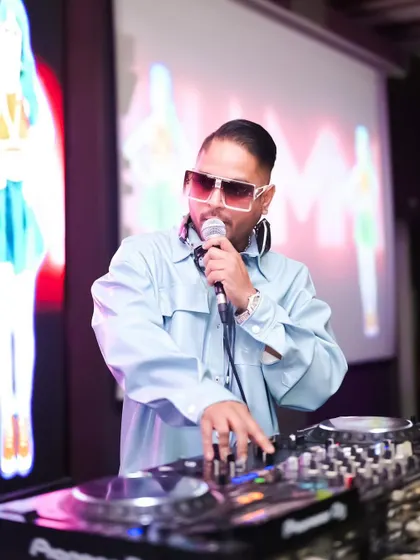 On the mic during the Aura NYE 2024 bash. I love interacting with the crowd, making announcements, and ensuring everyone feels like part of the celebration.
