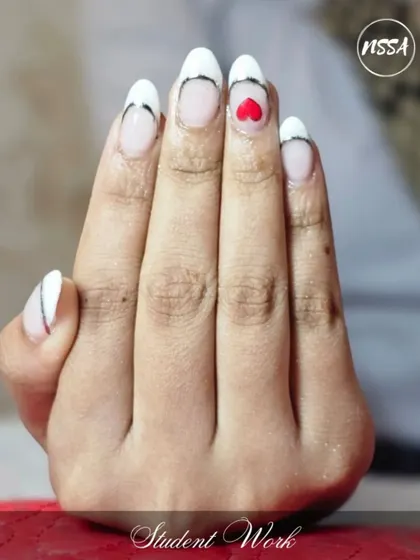 A minimalist design with a touch of love. This student's work features a clean French tip with a tiny red heart accent, proving that sometimes less is more.