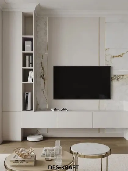 The entertainment center in this home is a masterclass in minimalist luxury, with a floating white console set against a stunning marble accent wall.