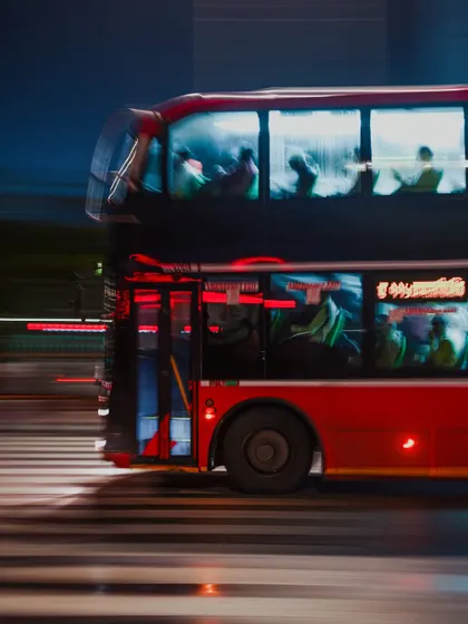 A series of night shots from the rainy streets of Mumbai, featuring motion-blurred double-decker buses and cars. These images capture the vibrant, electric energy of the city after dark.