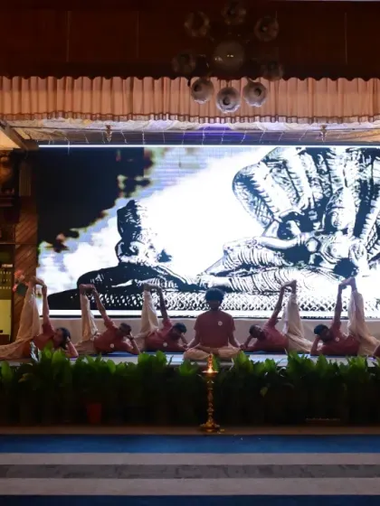 A dramatic moment from the "Creation to Dissolution" yogasana demonstration. The use of light and shadow, combined with the postures, created a mesmerizing visual narrative.
