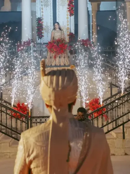 The groom awaits his bride, who makes a dramatic entrance on a grand staircase lined with pyrotechnics. We design these moments to be filled with anticipation and cinematic grandeur.