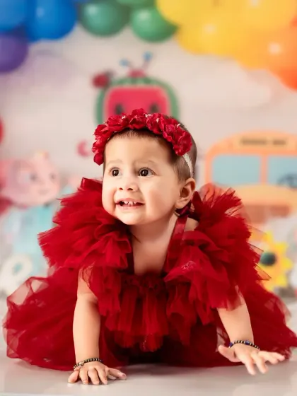 A happy crawl towards a new year! This little girl is all smiles in her Cocomelon-themed photoshoot.