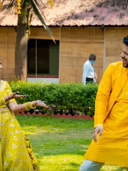 A playful moment between the bride and groom during their Haldi ceremony, capturing their infectious laughter.
