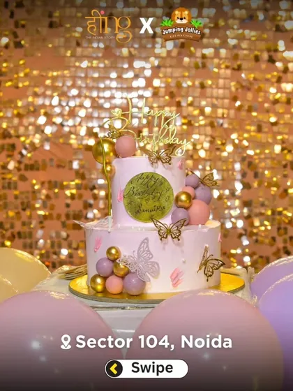 A beautiful two-tier cake with butterfly and gold accents, set against a sparkling gold sequin backdrop. A perfect centerpiece for a magical party.