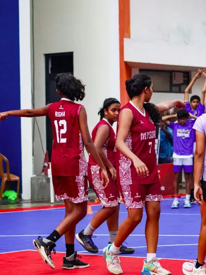 Teammates communicate on the court during a game. I emphasize the importance of teamwork and on-court chemistry for success.