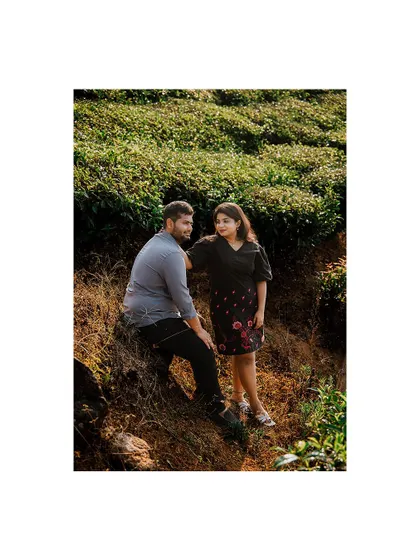 A serene moment with a couple in a tea plantation, enjoying the beautiful scenery.
