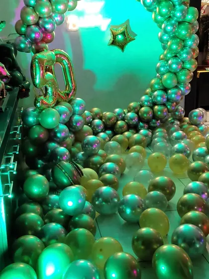 This photo shows the setup under green lighting, demonstrating how our decorations can be enhanced with different party lighting effects.