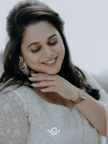 A beautiful, smiling portrait of a bride in a white dress, capturing a moment of pure happiness.