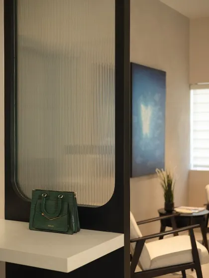 A detail shot of the office interior, featuring a handbag on the counter to give a sense of scale and everyday use.