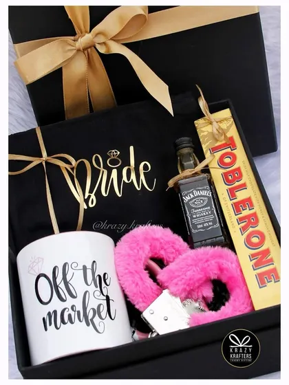 Off the market! A playful and naughty bachelorette hamper for the bride, featuring an 'Off the Market' mug, fluffy pink handcuffs, and a mini bottle of Jack Daniel's.