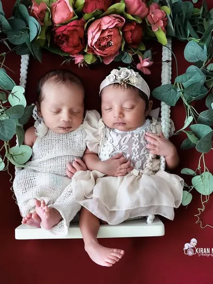 Double the sweetness. We are experienced in safely posing twins, shown here sleeping together on our floral swing prop.