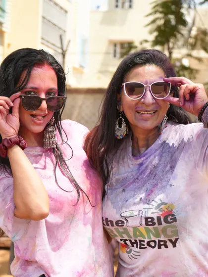 A cool, candid shot with a friend, both covered in colors. I help set a relaxed and fun tone for the party, making it a day to remember.