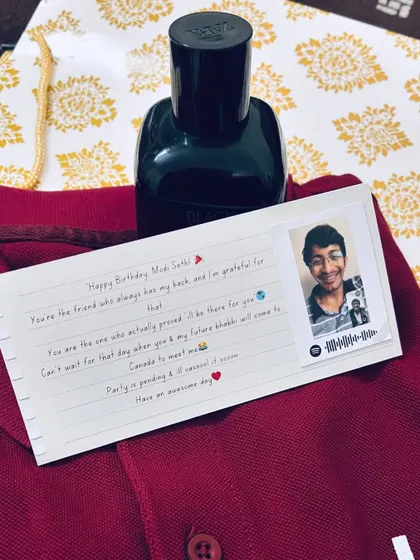 A personalized birthday card with a handwritten-style message and a small photo with a Spotify code.