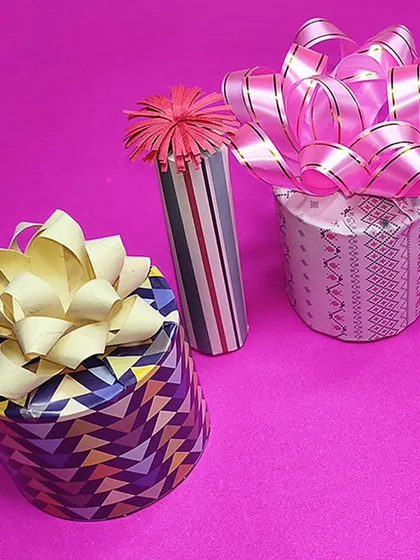 A variety of gift wrapping styles, featuring handmade paper bows and ribbons. Add a personal touch to your presents with these creative ideas.