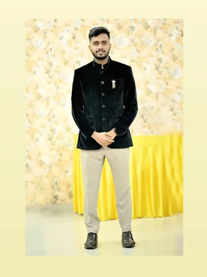A client wearing our black velvet Jodhpuri jacket. This is a great rental piece for a formal dinner or a wedding reception, offering a touch of luxury.