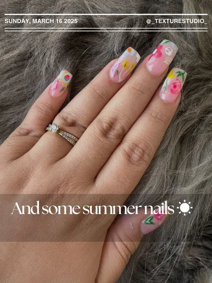 A close-up of these hand-painted summer floral nails. Each flower is detailed with care to create a beautiful, wearable garden on your fingertips.
