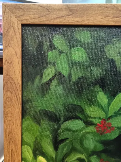 A detail shot of the custom wooden frame and the texture of the canvas.