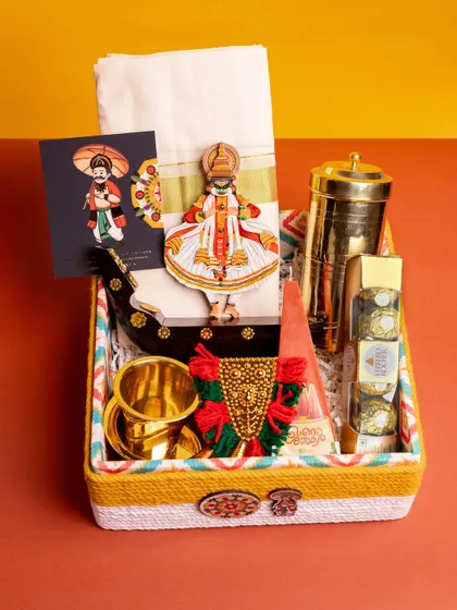A top-down view of the 'Kasavu & Katha' hamper, showing the meticulous arrangement of its diverse, culturally significant items within the custom box.