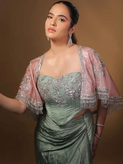 Adding a sheer pink jacket to the look adds a touch of softness and romance. The makeup is versatile enough to work with multiple styling options.
