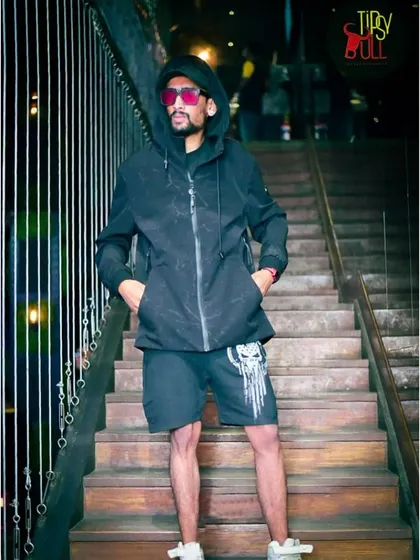A stylish shot on the stairs at a club. My personal style reflects the modern, energetic vibe of my music.