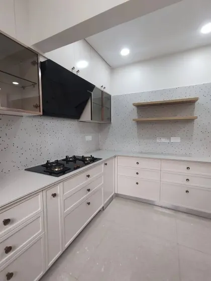 A duplicate of 70, showing the finished look of the white modular kitchen with its clean lines and minimalist appeal.