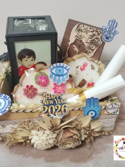 A still photo of the New Year hamper, showing the Urli candles, wooden portrait, and rotating lamp nestled in a decorative basket.