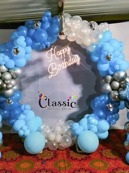 A Cinderella-themed balloon ring in shades of blue and silver, complete with a neon sign and character cutouts.