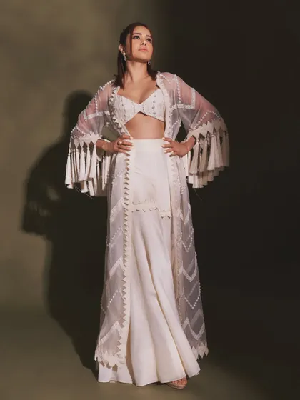 The full look of this pearl and tassel indo-western outfit. It's a great example of how to wear white to a festive event in a non-traditional way.