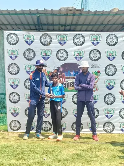 A young player is celebrated by his teammates and coaches as he receives an award.