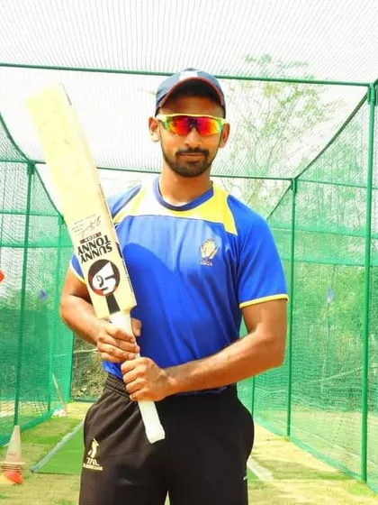 Aditya Mani, a proud product of our academy, holding his bat before a net session. His selection for the Bangalore City XI in the U-23 KSCA Inter Zonal tournament was a key step in his career.