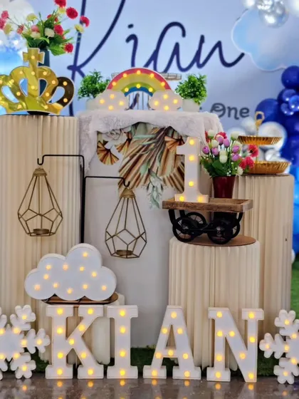 A charming teddy bear-themed first birthday with light-up letters, a marquee number '1', and cozy props like a teddy bear and decorative snowflakes.