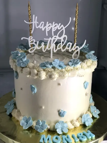 A simple and elegant cake with delicate blue flowers.