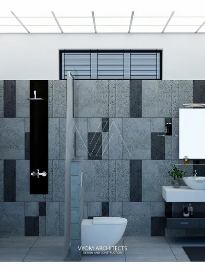 A modern toilet design using a combination of dark and light grey textured tiles in a geometric pattern. A skylight provides ample natural illumination, making the space feel bright and airy.