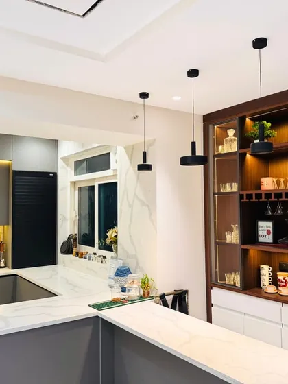 A view of a kitchen pass-through window connecting to a bar area, showing how I design spaces for seamless entertaining and flow.