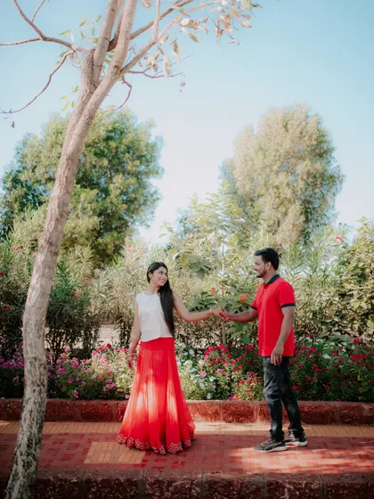 A sweet moment from a pre-wedding shoot in a beautiful garden setting.