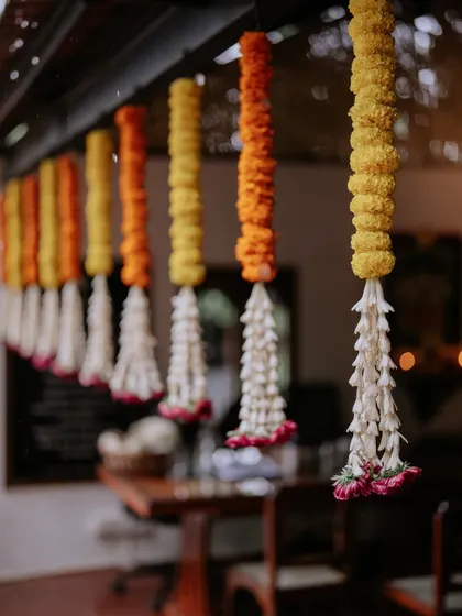 Hanging floral strings of marigold and tuberose, a classic element in South Indian wedding decor.