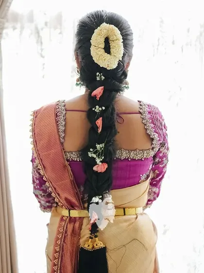 The back view of Kavya's housewarming look, showing her beautiful hairstyle and blouse details.