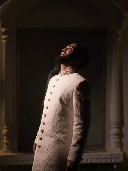 A groom's portrait is about capturing his quiet confidence and anticipation. This shot uses dramatic lighting to create a powerful, stylish image that tells a story of the man he is on his wedding day.