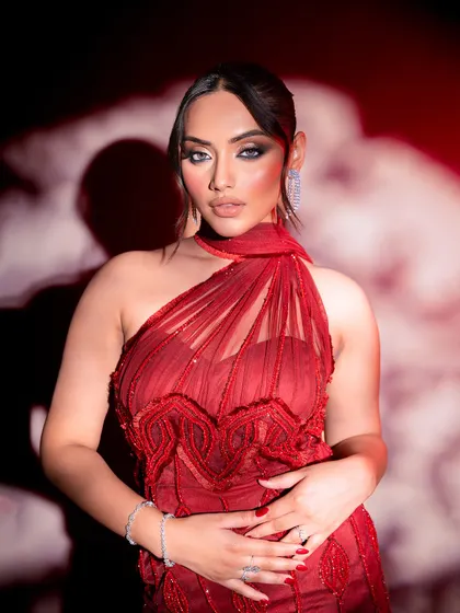 Another angle of the stunning red gown, highlighting the intricate beadwork and modern cut. This is for the bride who is confident and loves contemporary design.