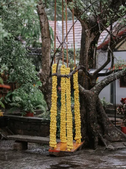 A clear shot of the marigold-decorated swing, a perfect spot for photos and a key element of the Haldi decor, blending tradition with playful charm.