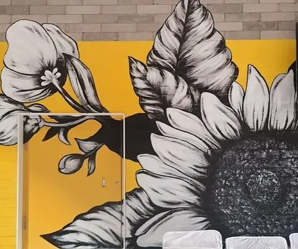 A close-up of the large, monochrome sunflower, detailing the intricate linework and shading.