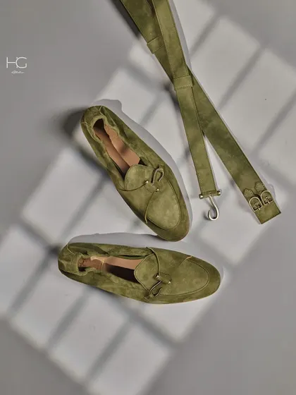 A complete look at the olive green suede loafers and matching belt. These accessories are crafted to add a touch of sophisticated color to any outfit.