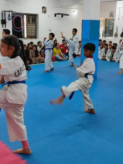 A student practices a front kick.