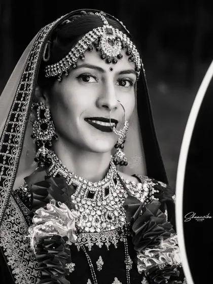 A timeless black and white portrait of the bride, her smile shining brightly. This style emphasizes emotion and expression.