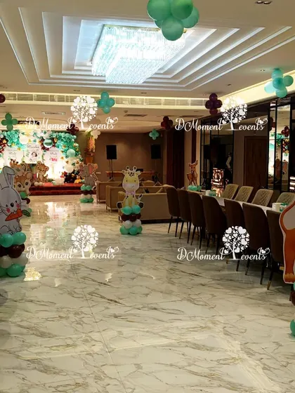 The jungle theme is carried throughout the venue with freestanding animal cutouts on balloon bases, adding a playful touch to the entire space.